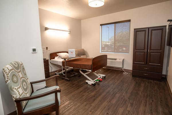 A well-furnished private resident room with medical bed