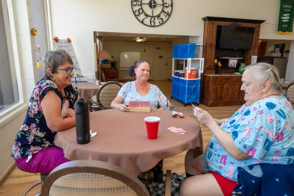 Residents playing cards in a common area