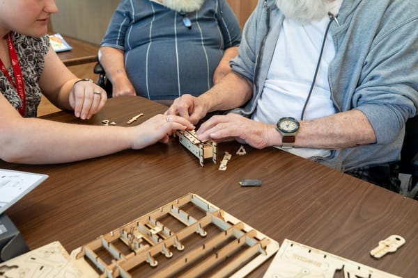 Residents engaging in a hands-on activity at a table