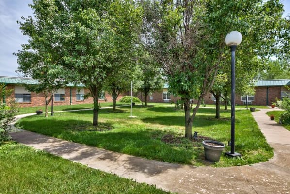 Lush green courtyard with trees and walkways