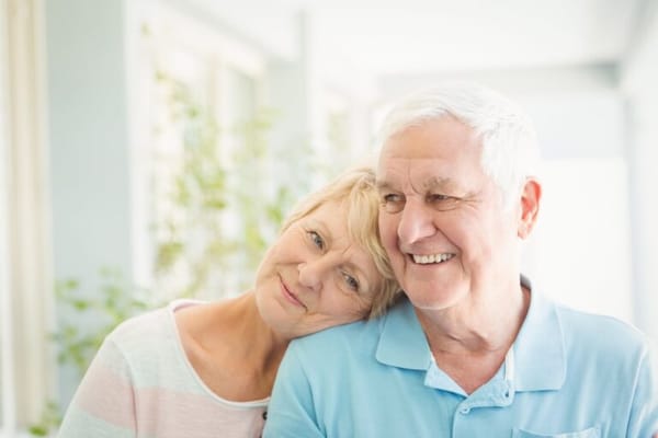 Two residents smiling together in a bright interior