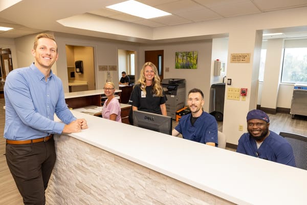 Staff members smiling at the reception desk