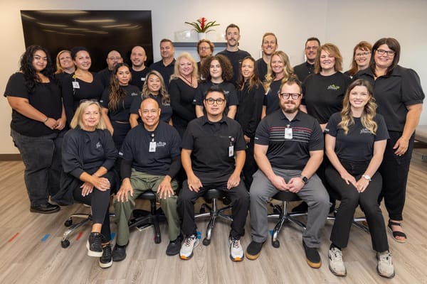 Staff members posing together in a communal area