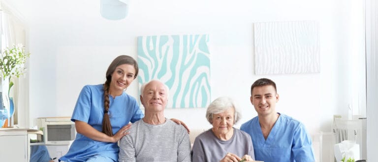 Residents and staff in a bright activity room