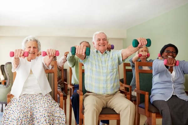 Residents participating in a group exercise class indoors