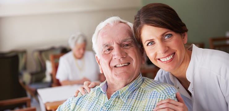 Staff member and resident smiling in a common area