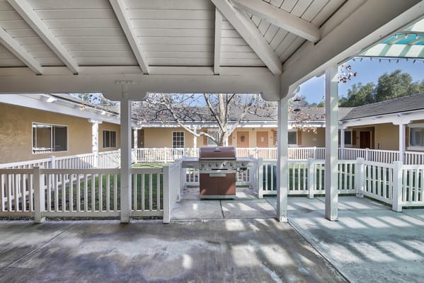 Outdoor patio area with a barbecue grill and seating