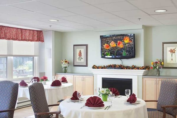 Dining area decorated with flowers and table settings