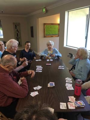 Seniors playing cards in a common area