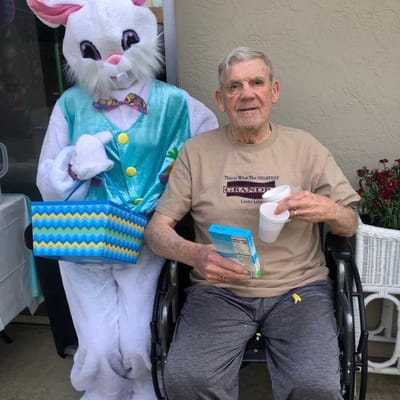 A resident with the Easter Bunny in a festive setting