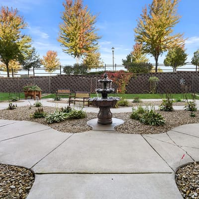 A peaceful garden area with a fountain and benches