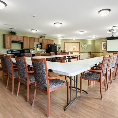 Common area with tables and chairs in the facility