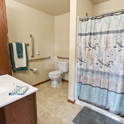 Private bathroom with safety features and decor