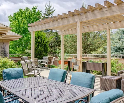 Outdoor patio area with seating and greenery