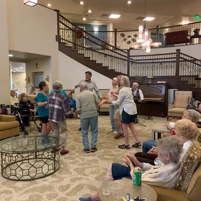 Residents and staff dancing in a common area