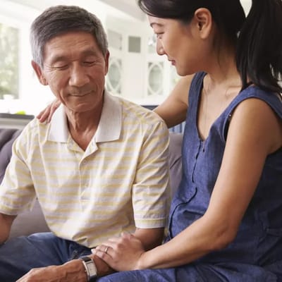 A caregiver interacting warmly with a resident