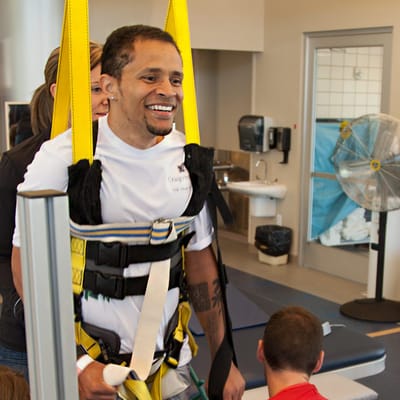 Therapist assisting a resident with rehabilitation equipment