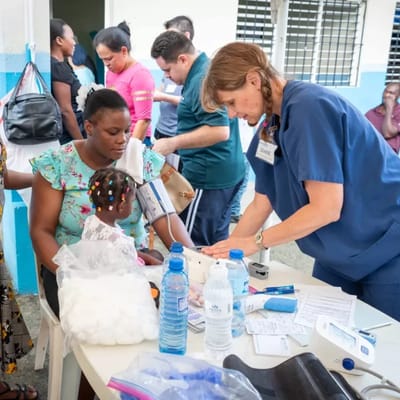 A nurse assisting a child during a health check-up