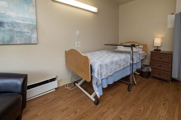 Private resident room with a hospital bed and furniture