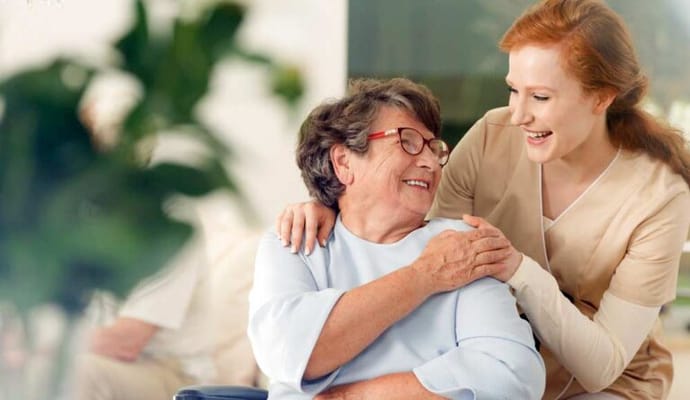 Staff member assisting a resident in a warm interaction