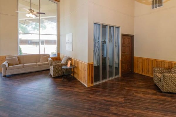 Bright common area with seating and large windows