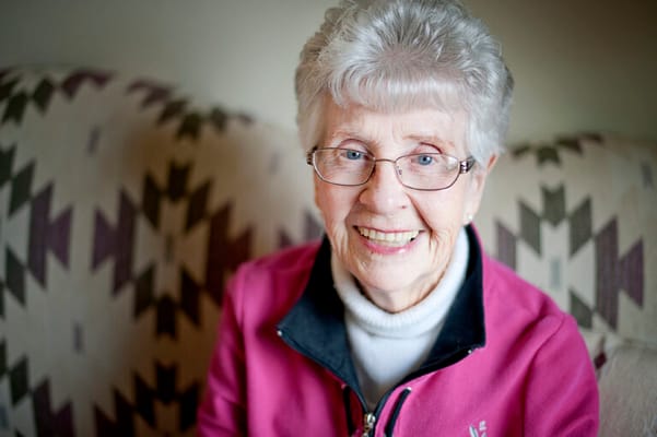 Smiling senior woman in a pink sweater