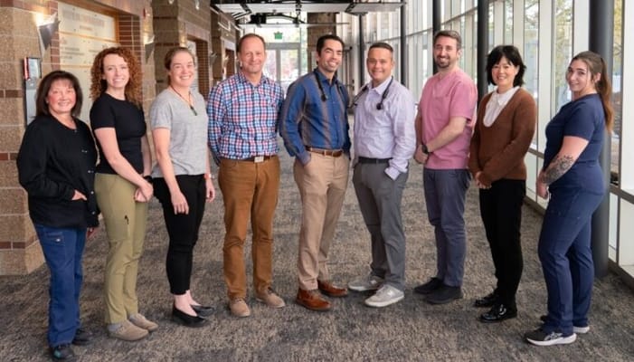 Staff members posing in a hallway
