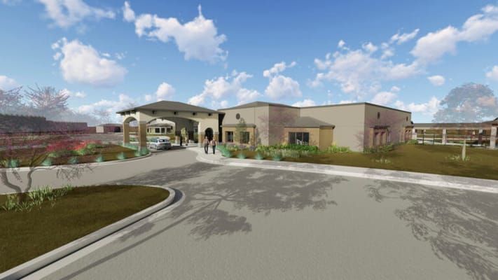 Exterior view of Bluestem Village with residents arriving