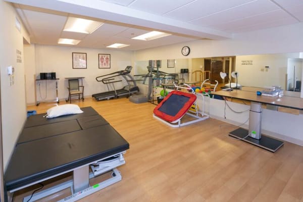 Therapy room with exercise equipment and therapy table