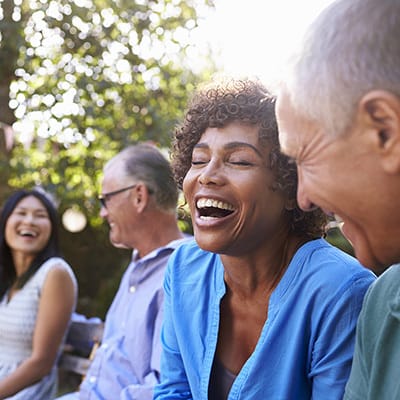 Four residents enjoying a sunny outdoor moment together
