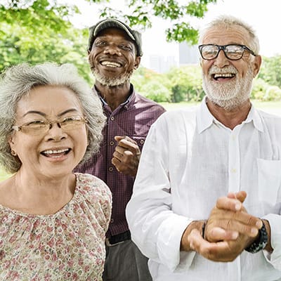 Three happy seniors enjoying a sunny outdoor day