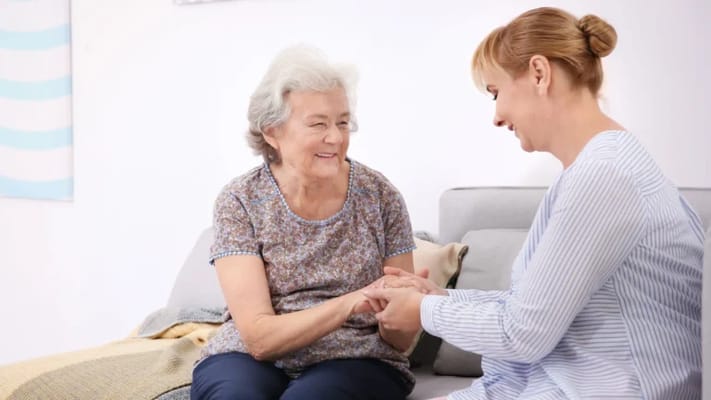 Caregiver interacting with a resident in a cozy environment