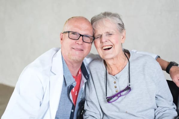 Caregiver and resident sharing a joyful moment