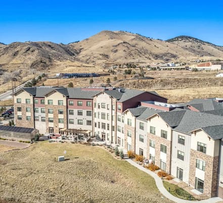 Aerial view of the Golden Assisted Living facility against mountain backdrop