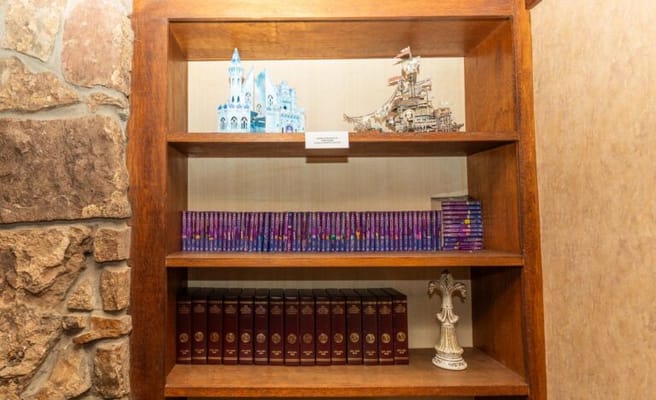 Books and decorative items on a wooden shelf