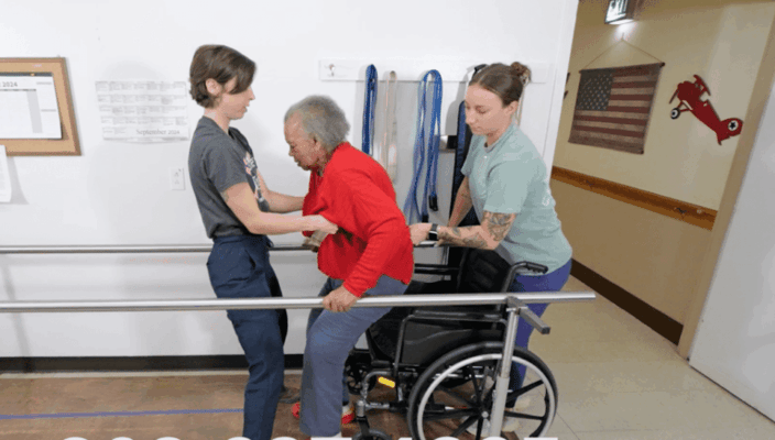 Staff assisting a resident with mobility