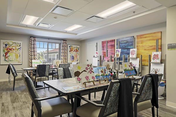 Art activity room with works displayed on tables
