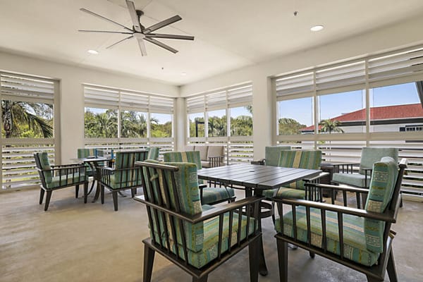 Bright common area with seating and large windows