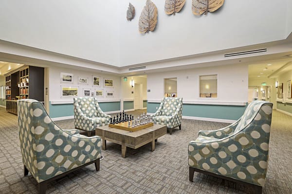 Bright common area with seating and chess set