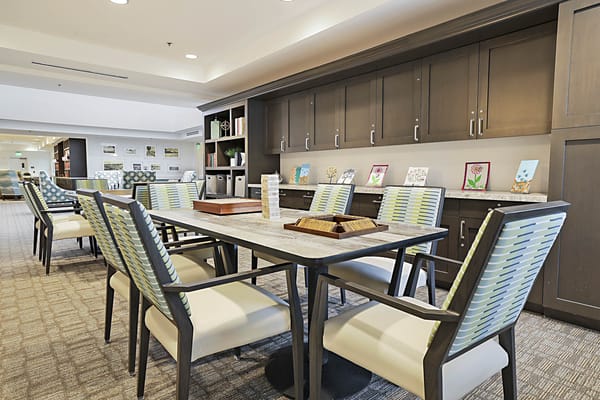 Bright common area with dining tables and chairs
