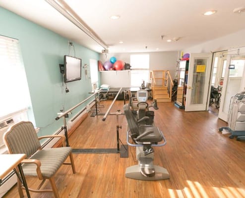 Rehabilitation gym with exercise equipment and therapy space