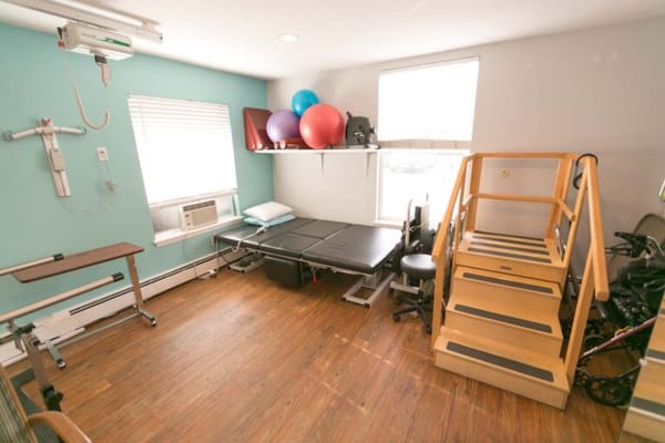 Rehabilitation room with exercise equipment and therapy stairs