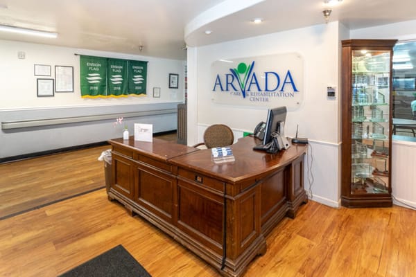 Reception area with wooden desk and signage