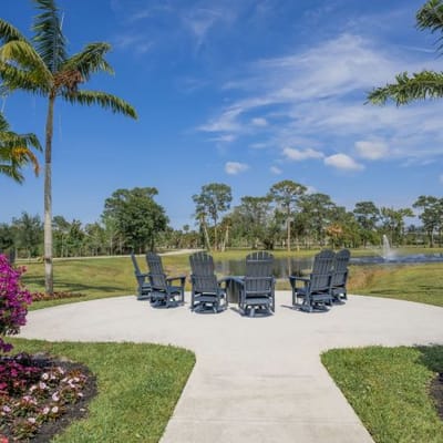 Outdoor seating area by a serene pond