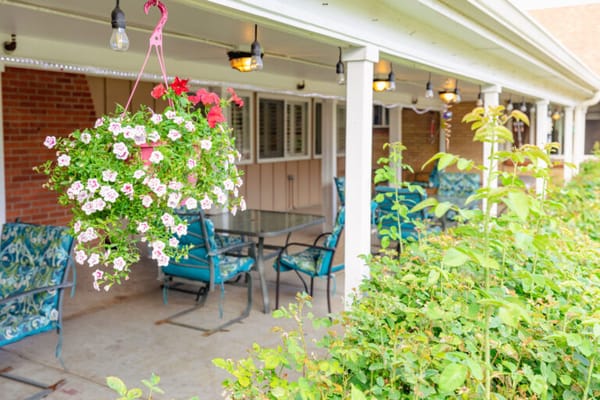 Outdoor seating area with flowers and chairs