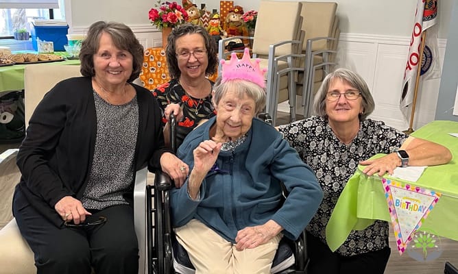 Residents celebrating a birthday in an activities room