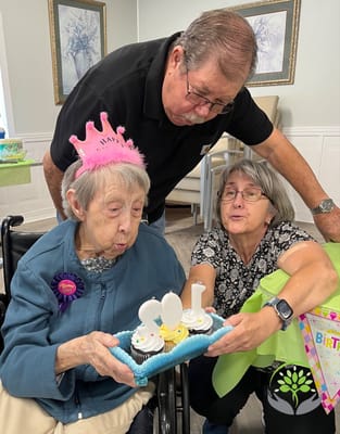 Residents celebrating a birthday with cupcakes