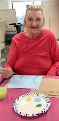 Resident painting during an art activity