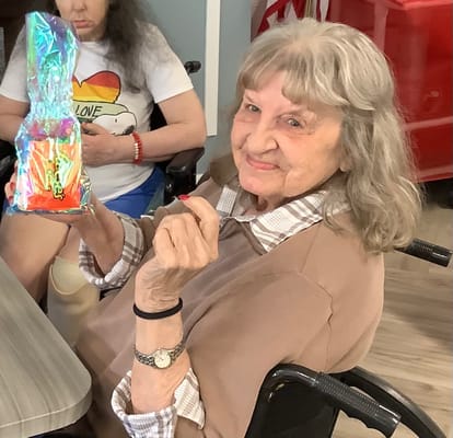 Resident enjoying an activity with colorful decoration