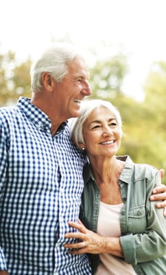 Elderly couple smiling together outdoors
